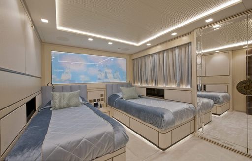 Guest cabin onboard boat charter SCORPION, twin berths and a large mirror