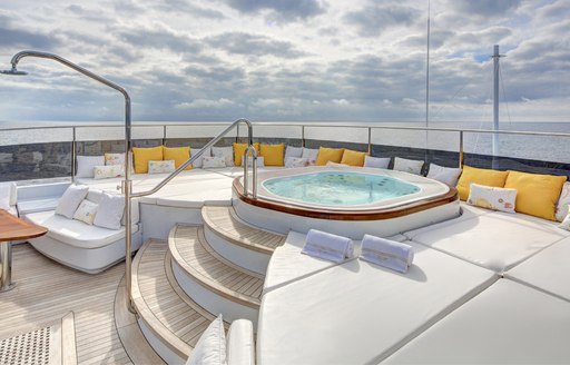 Spa pool on sundeck of luxury yacht Baron Trenck, with sunpads surrounding and shower 