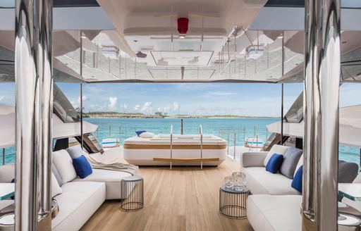 charter yacht vista blue sundeck with spa pool and sofas flanking the space