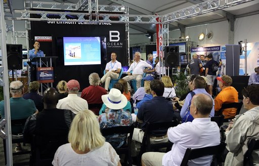 FLIBS seminar, man on stage giving presentation