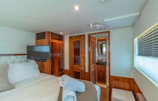 Guest cabin with central double berth and entrance to ensuite aft onboard sailing yacht charter CRAZY LOVE