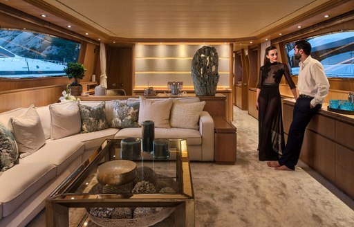 Charter guests relax in main salon of luxury yacht AMAYA