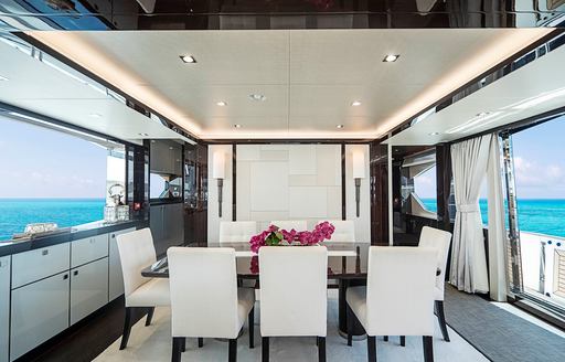 Charter yacht QUANTUM interior dining area with large windows