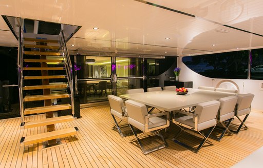 alfresco dining table on the main deck aft of charter yacht SAHANA