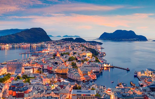 From the bird's eye view of Alesund port town on the west coast of Norway, at the entrance to the Geirangerfjord. Colorful sunset in the North.