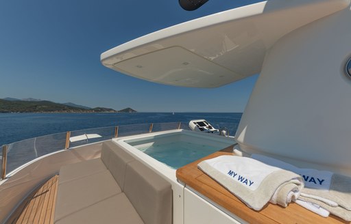 View across sunloungers to Jacuzzi dip pool on Motor yacht 'My Way'