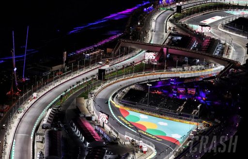 Overview of Jeddah Corniche Circuit at night, bends in the track visible, lit by floodlights.