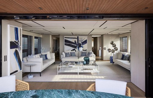 Main salon onboard charter yacht LA LA LAND, spacious lounge area with plush white seating