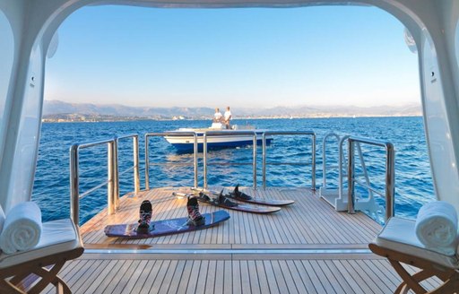 swim platform on superyacht natita at sunset with water toys and tender