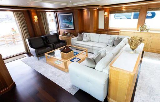 Main salon onboard charter yacht INVICTUS with white sofas