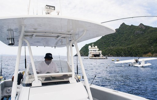 tender in foreground with seaplane and superyacht SuRi beyond