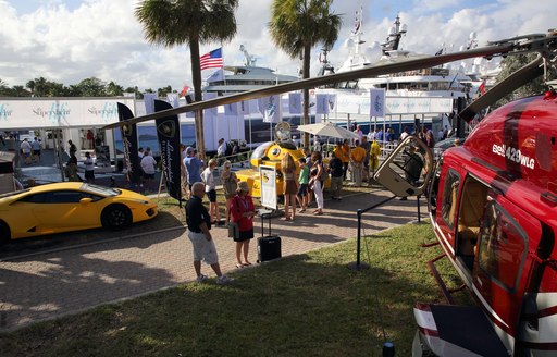 cars, helicopters and other exhibitors at the Fort Lauderdale International Boat Show