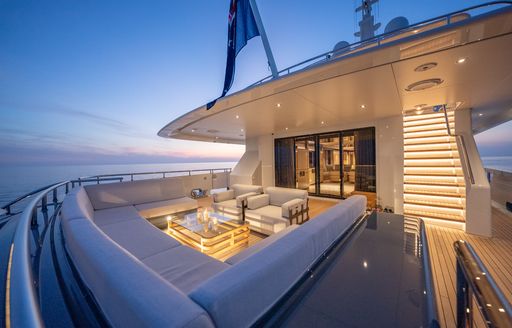 Exterior seating on the aft deck onboard charter yacht RELIANCE at dusk