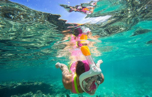 Girl snorkelling in the clear waters of Antigua, the Caribbean