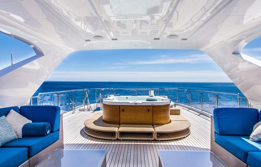 Luxury yacht LULU sundeck, with jacuzzi pool and blue sofa seating