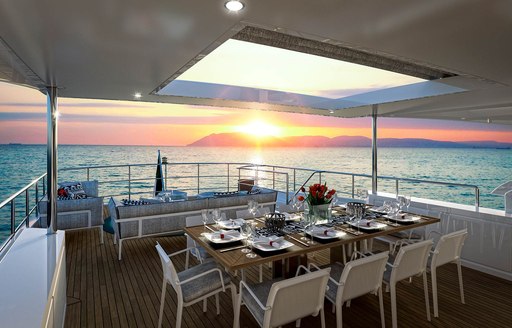 A dining table situated on the exterior of superyacht URAMIR