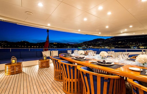 alfresco dining at night on board superyacht MISCHIEF