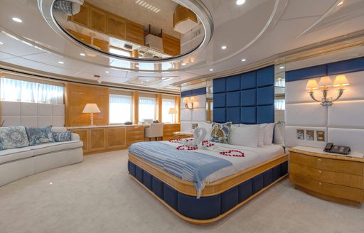 Overview of master cabin with central berth and a seating area onboard charter yacht LADY AZUL