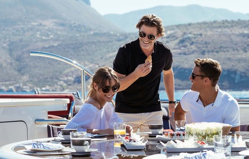 a family enjoying a light meal prepared by the deft and expert hands of their on board chef who is following completely up-to-date health and safety protocol 