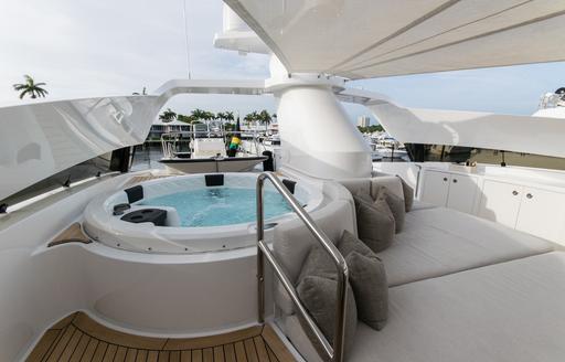 Deck Jacuzzi and sun pads onboard charter yacht INVICTUS