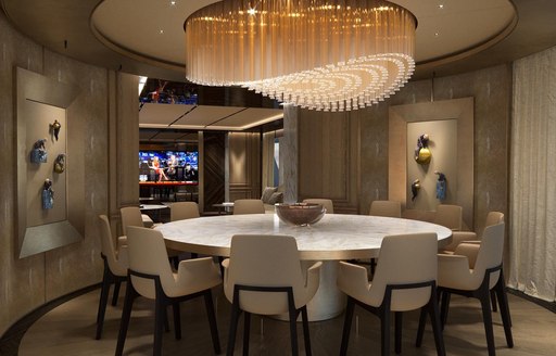 chandelier hanging above the round dining table of superyacht GECO