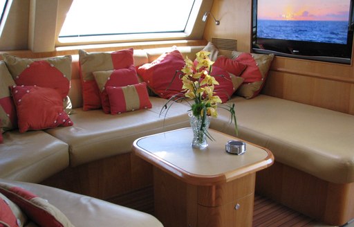 Comfortable seating and tv in main salon of luxury yacht orion