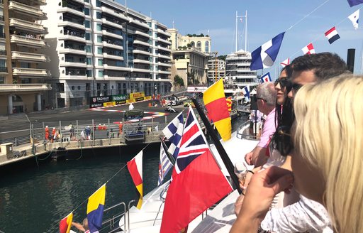 spectators watch the Monaco Grand Prix from the deck of a superyacht 