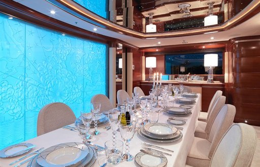 Blue light panels in the walls behind dining salon on superyacht LATITUDE