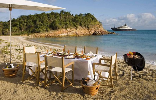 luxury yacht beach set up with umbrella and table 