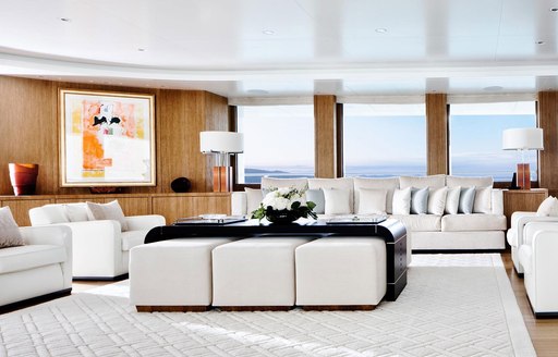 sumptuous white sofas in the main salon of charter yacht Lady E