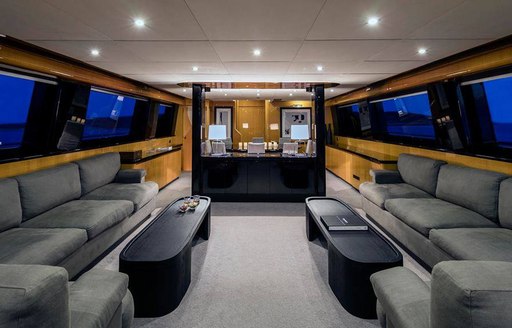 superyacht cant remember main salon with gray sofas and black coffee tables