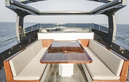 seating area with table on the sundeck of luxury yacht Timeless 