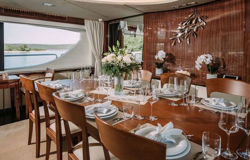 Charter yacht ARTEMY interior dining area with long table