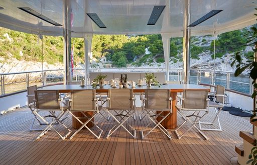 Exterior dining table onboard yacht rental MARALLURE