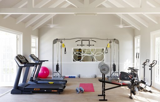 gym in villa of thanda island, with treadmills and other gym equipment