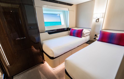 Twin berth with a small window onboard charter yacht CARPE DIEM