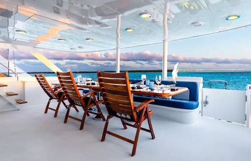 Charter yacht ESCAPE alfresco dining table and chairs