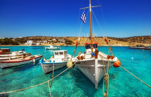 small fishing boats on the water in harbour in greece