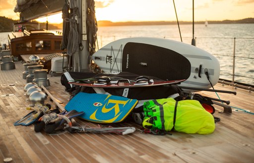 Varied collection of water toys lined up on deck of charter yacht RAINBOW