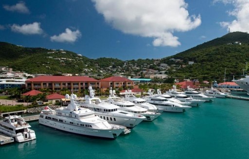 A collection of white superyachts docked in St Martin Marina