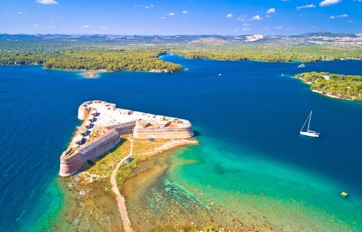 red clay building on the shores of croatia, aerial view