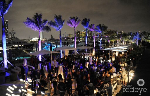 The Deck filled with guests at night on Island Gardens Deep Harbour