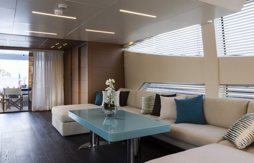 Comfortable sofa and table inside on superyacht 55 FIFTYFIVE