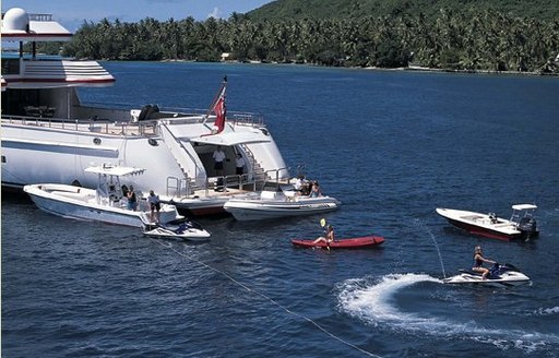 Beach club onboard charter yacht NOMAD with charter guests enjoying multiple water toys around the yacht