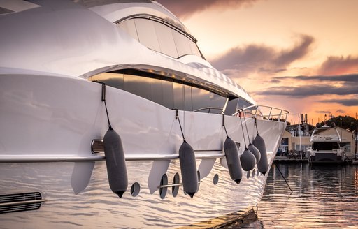 Starboard side of a motor yacht at sunset