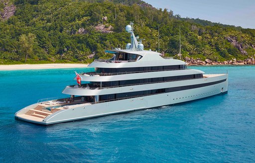 Overview of charter yacht SAVANNAH at anchor with beach in the background