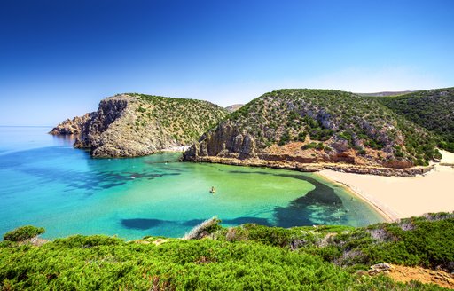 the crystal clear water on la maddalena archipelago in italy's shoulder seaon where they experience less tourism