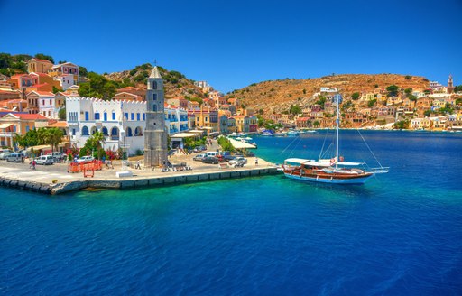 yacht on the water in harbour of town in greece