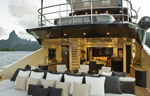 Al fresco dining and sun pads on main deck of superyacht VANTAGE