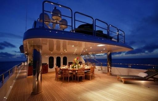 alfresco dining on the bridge deck aft at night on board charter yacht ‘Top Five’ 